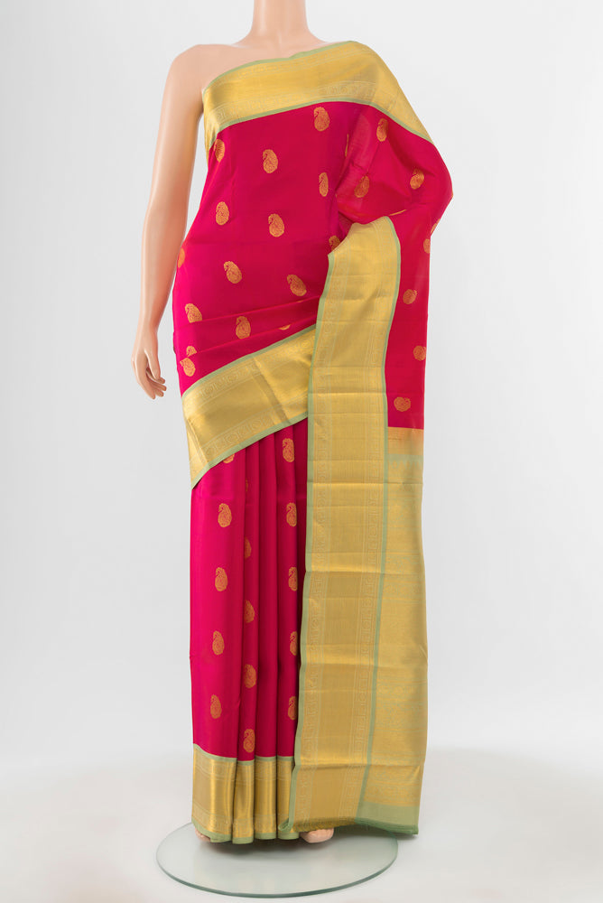 Pure Silk Pure Zari Peach Kanchipuram Saree with Zari Butta on the body and Silk Border.  displayed on a mannequin