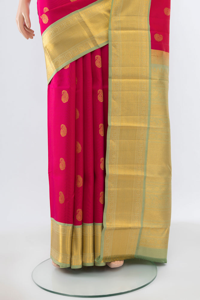 Pleats and pallu of Pure Silk Pure Zari Peach Kanchipuram Saree with Zari Butta on the body and Silk Border. 