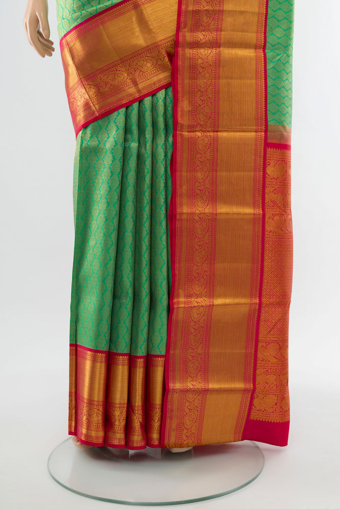Pleats and pallu of Light Green Kanjivaram Silk Saree with Zari Butta on the body and Silk Border. 