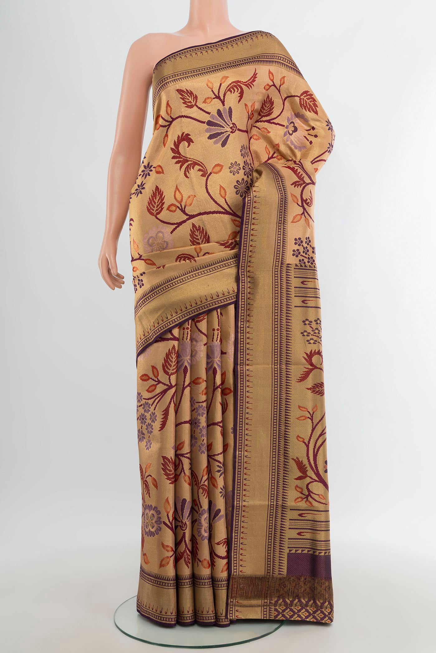 Golden Kanchipuram Tissue Silk Saree with Zari Brocade on the body and Zari Border.  displayed on a mannequin