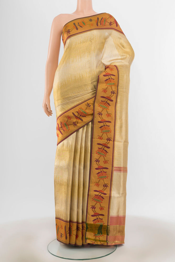 Golden Kanchipuram Silk Saree with Zari Butta on the body and Silk Border.  displayed on a mannequin