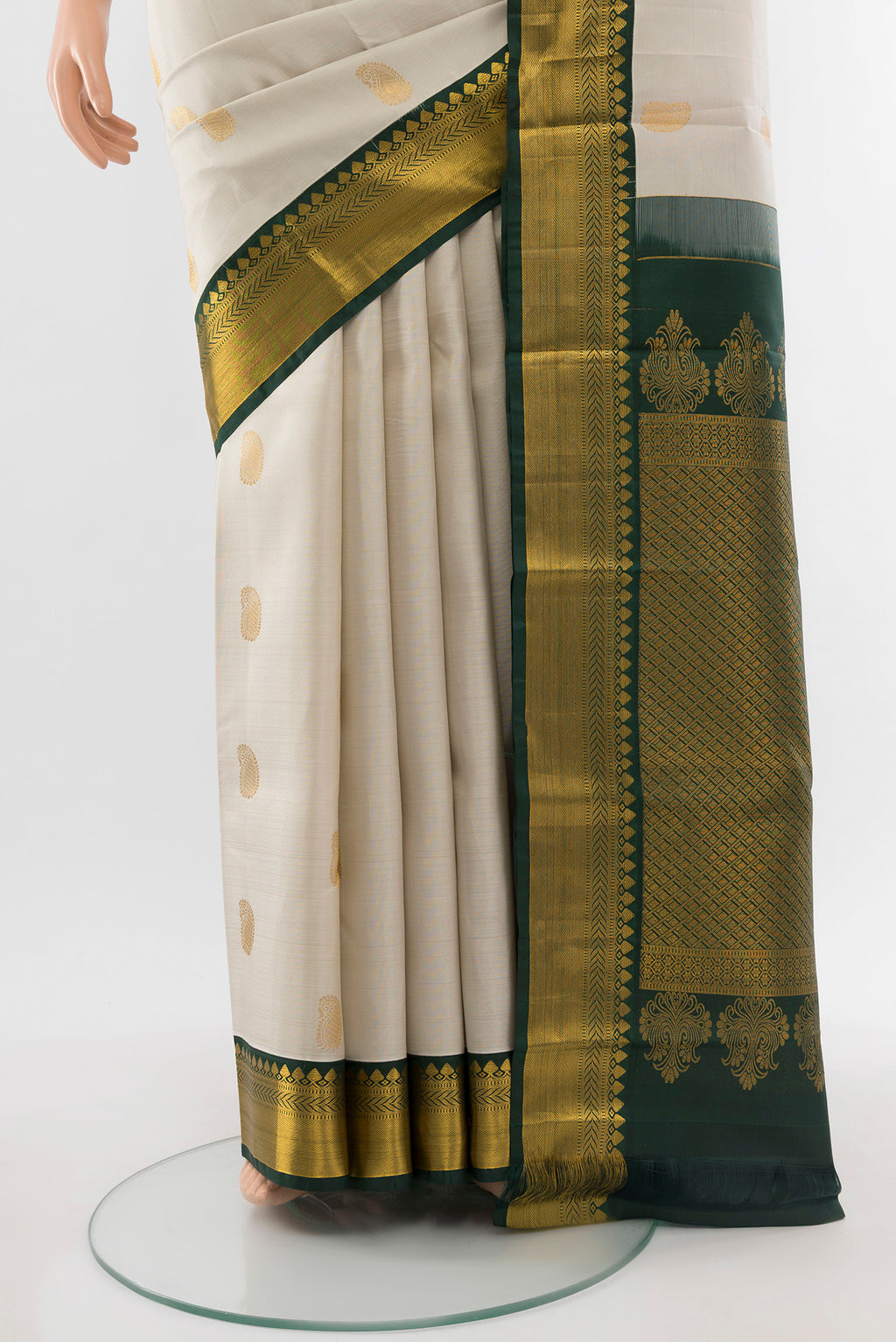 Pleats and pallu of Pure Silk Pure Zari Cream Kanchipuram Saree with Zari Butta on the body and Silk Border. 