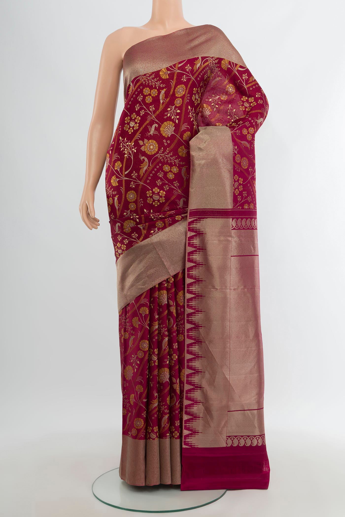 Magenta Kanjivaram Silk Saree with Zari And Thread Butta on the body and Zari Border.  displayed on a mannequin