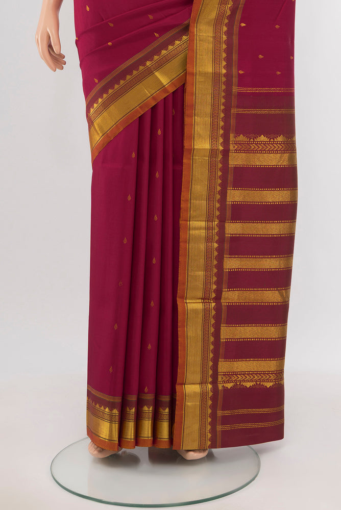 Pleats and pallu of Maroon Kanchipuram Silk Saree with Zari Butta on the body and Silk Border. 