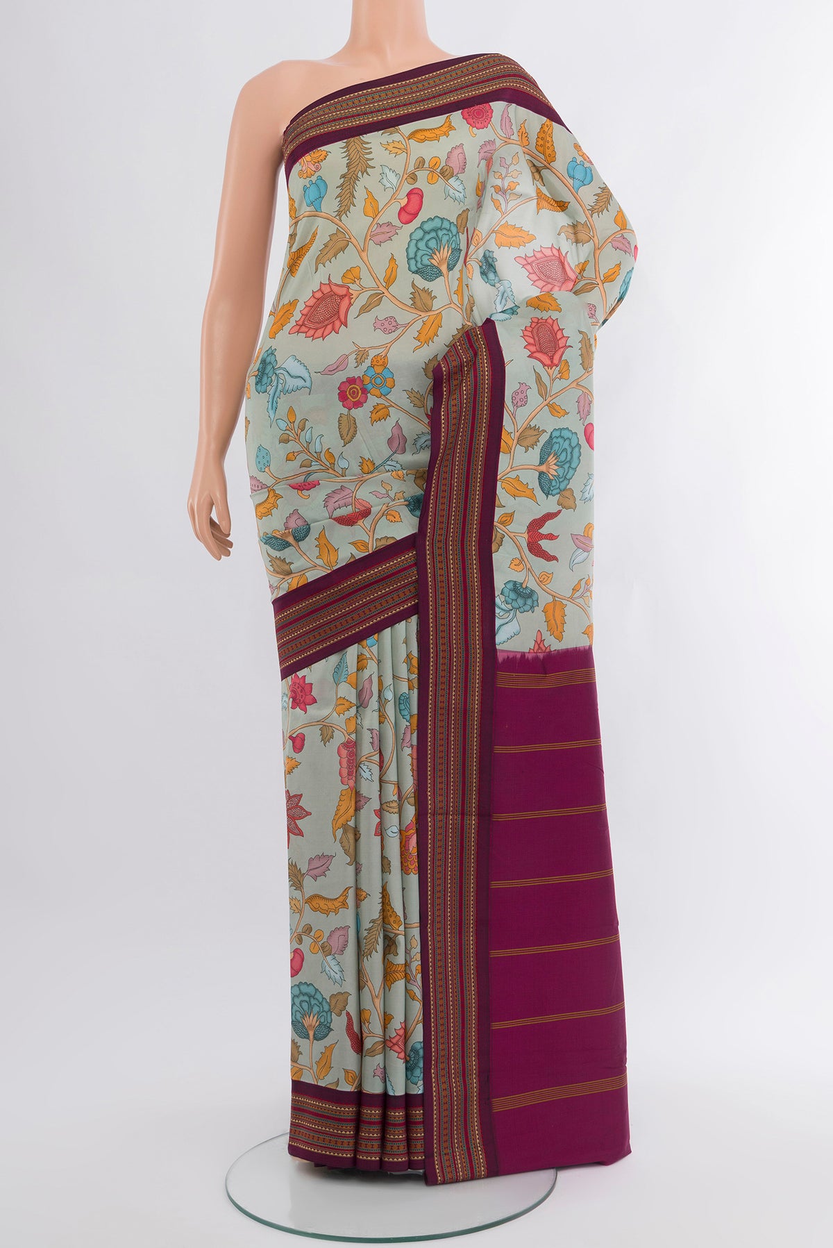 Grey Printed Silk Saree with Floral Print on the body and Zari Border.  displayed on a mannequin