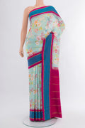 Sky Blue Printed Silk Saree with Floral Print on the body and Rising Temple Border.  displayed on a mannequin