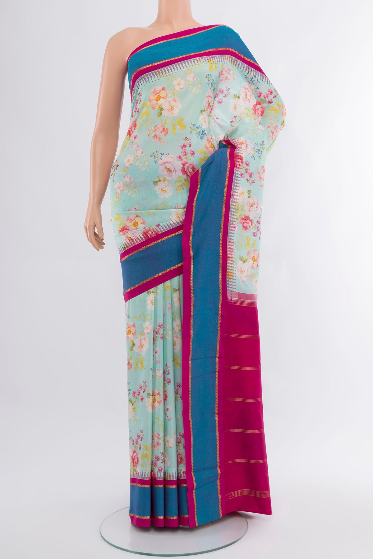 Sky Blue Printed Silk Saree with Floral Print on the body and Rising Temple Border.  displayed on a mannequin