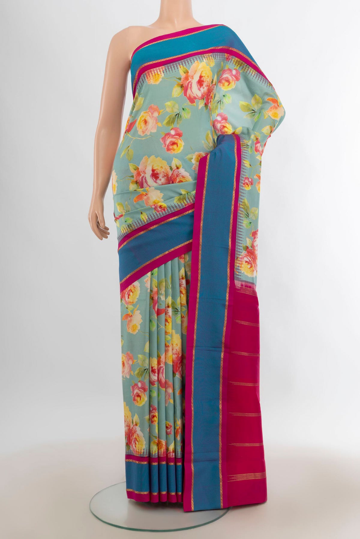 Pure Silk Mint Green Printed Saree with Floral Print on the body and Plain Border.  displayed on a mannequin