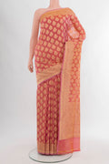 Coral Banarasi Silk Saree with Zari Butta on the body and Zari Border.  displayed on a mannequin