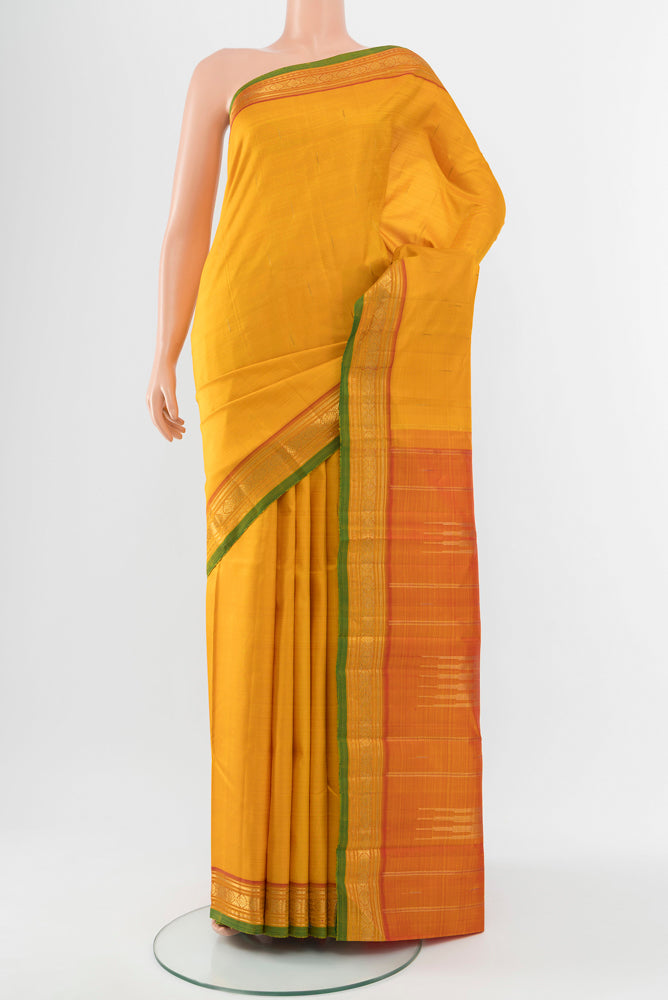 Yellow Kanjivaram Silk Saree with Zari Butta on the body and Silk Border.  displayed on a mannequin