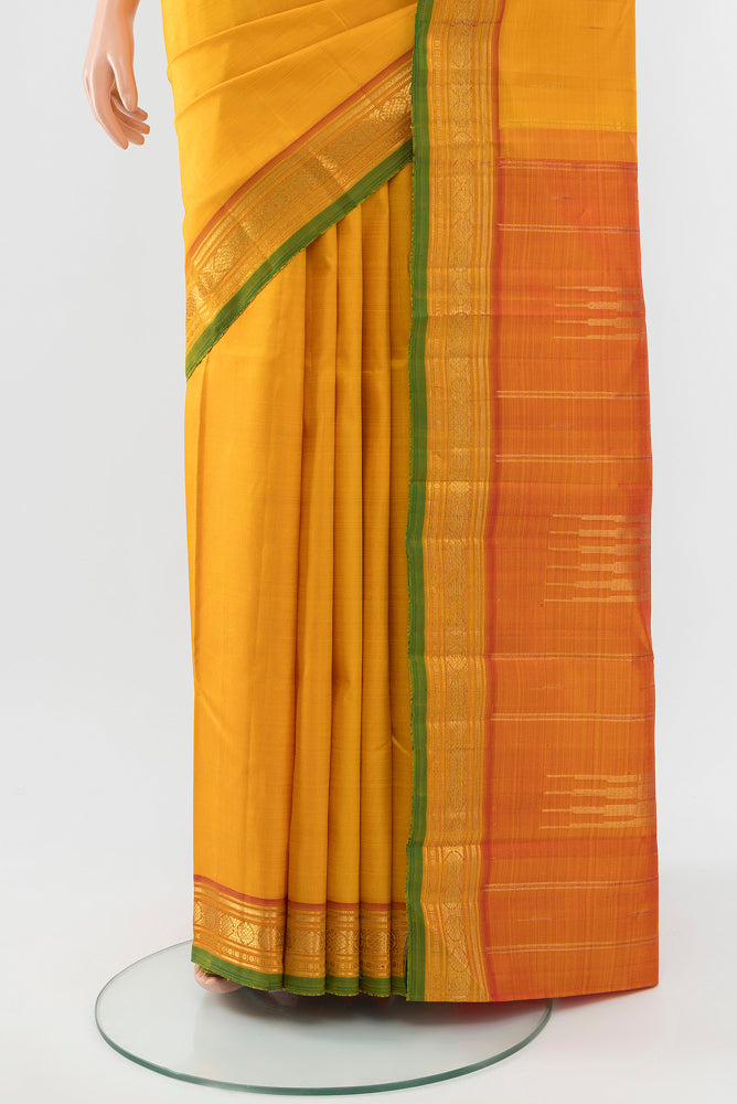 Pleats and pallu of Yellow Kanjivaram Silk Saree with Zari Butta on the body and Silk Border. 