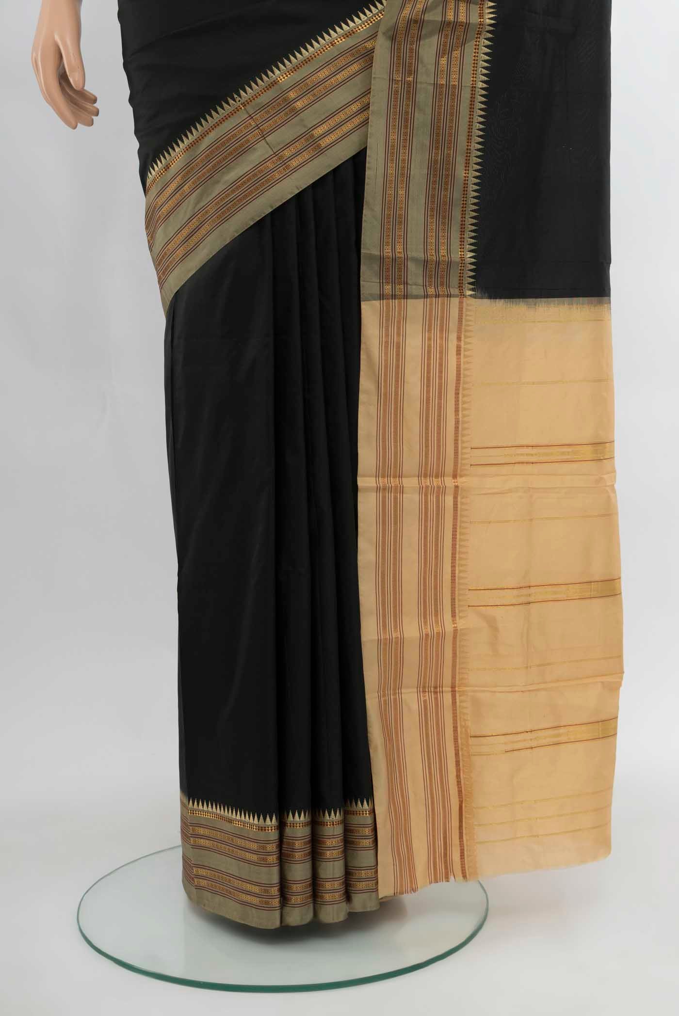 Pleats and pallu of Black Narayanpet Silk Saree with Zari Butta on the body and Silk Border. 