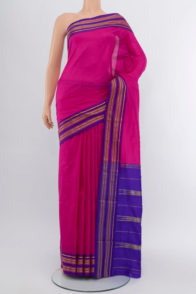 Magenta Narayanpet Silk Saree with Zari Butta on the body and Silk Border.  displayed on a mannequin