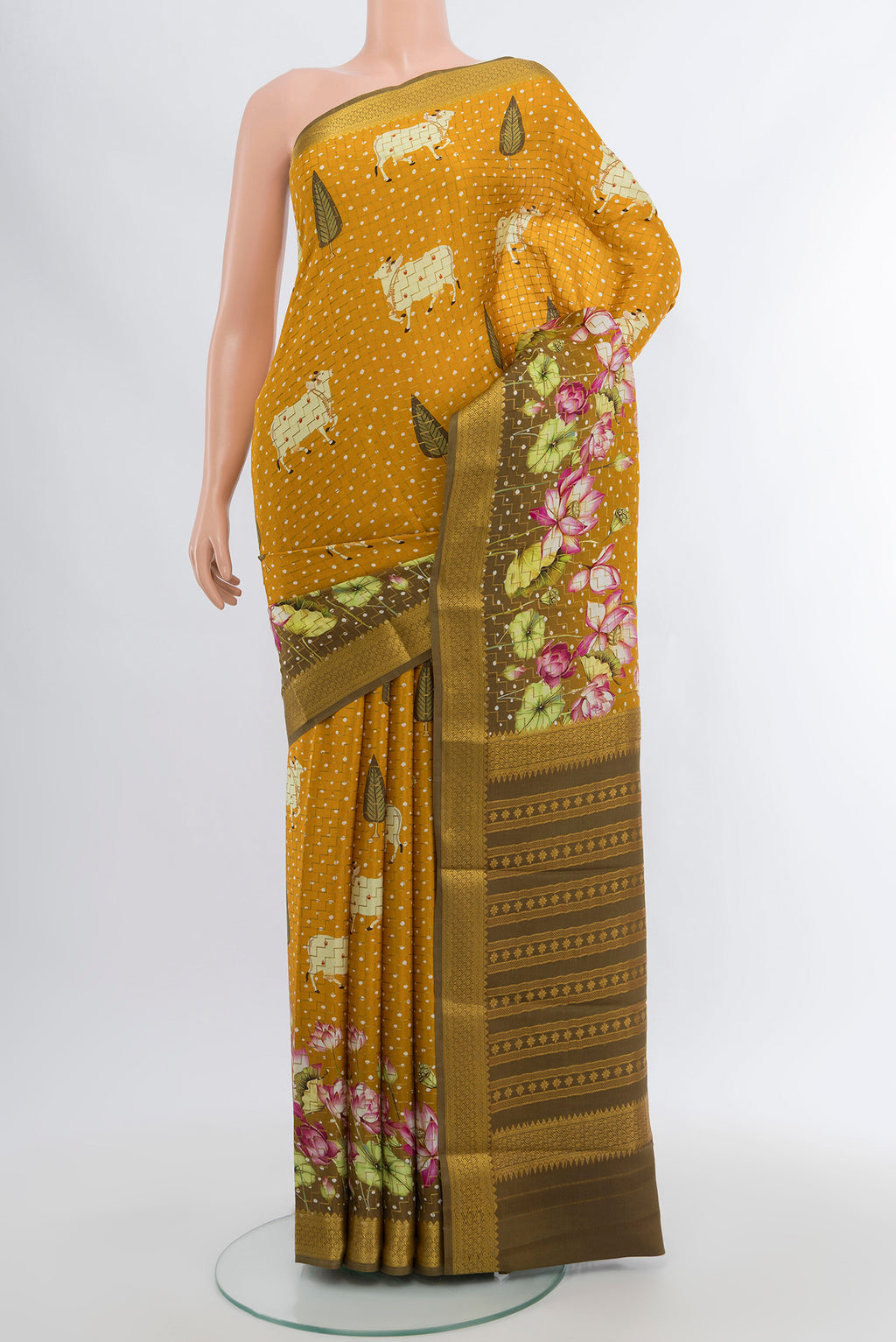 Mustard Mysore Crepe Saree with Floral Print on the body and Zari Border.  displayed on a mannequin