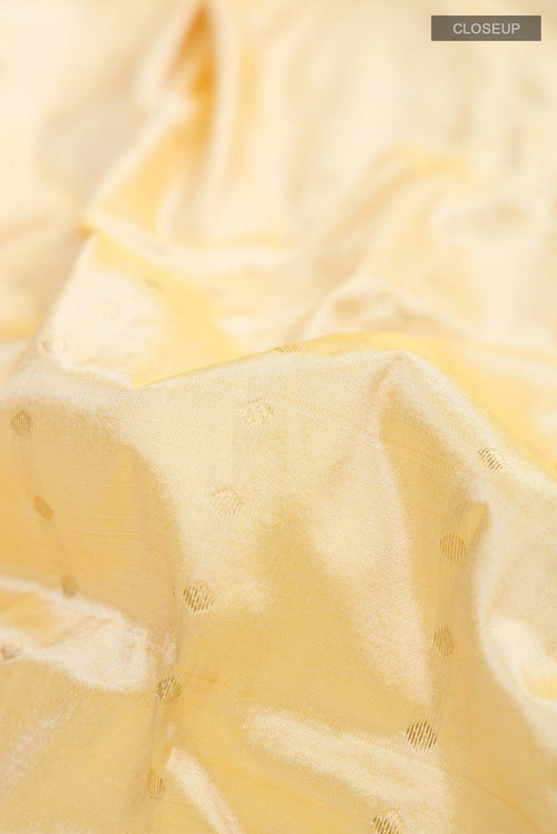 Close up of Beige Bangalore Silk Saree with Zari Butta on the body and Zari Border displaying folds
