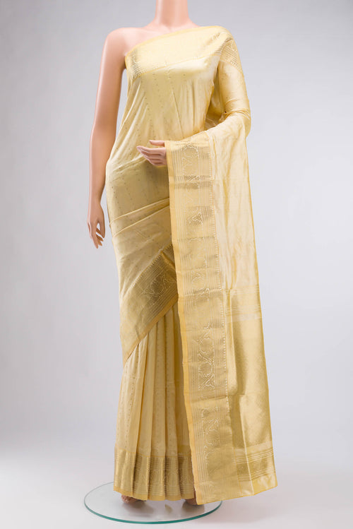 Beige Bangalore Silk Saree with Zari Butta on the body and Zari Border displayed on a mannequin
