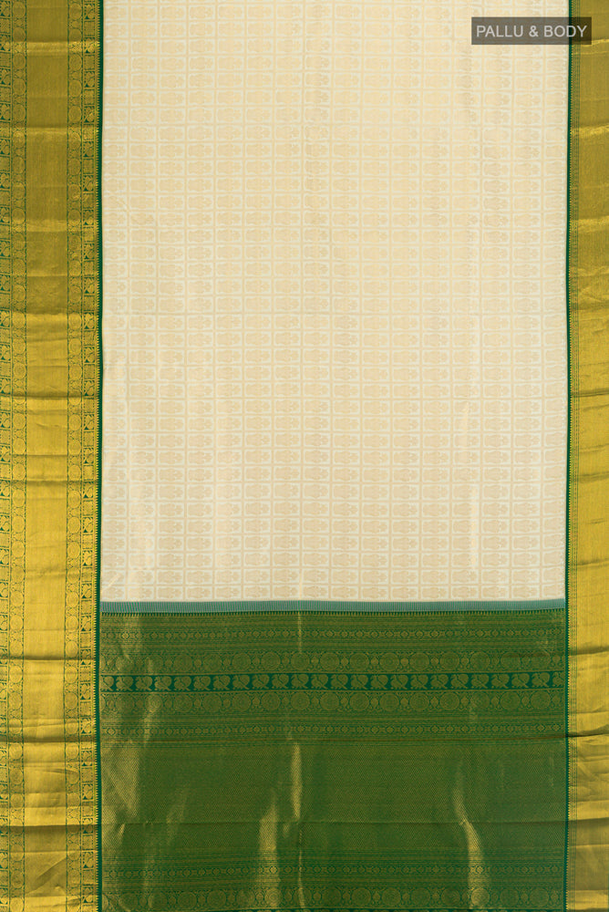 Flat view of Golden Kanchipuram Silk Saree with Zari Butta on the body and Silk Border. 