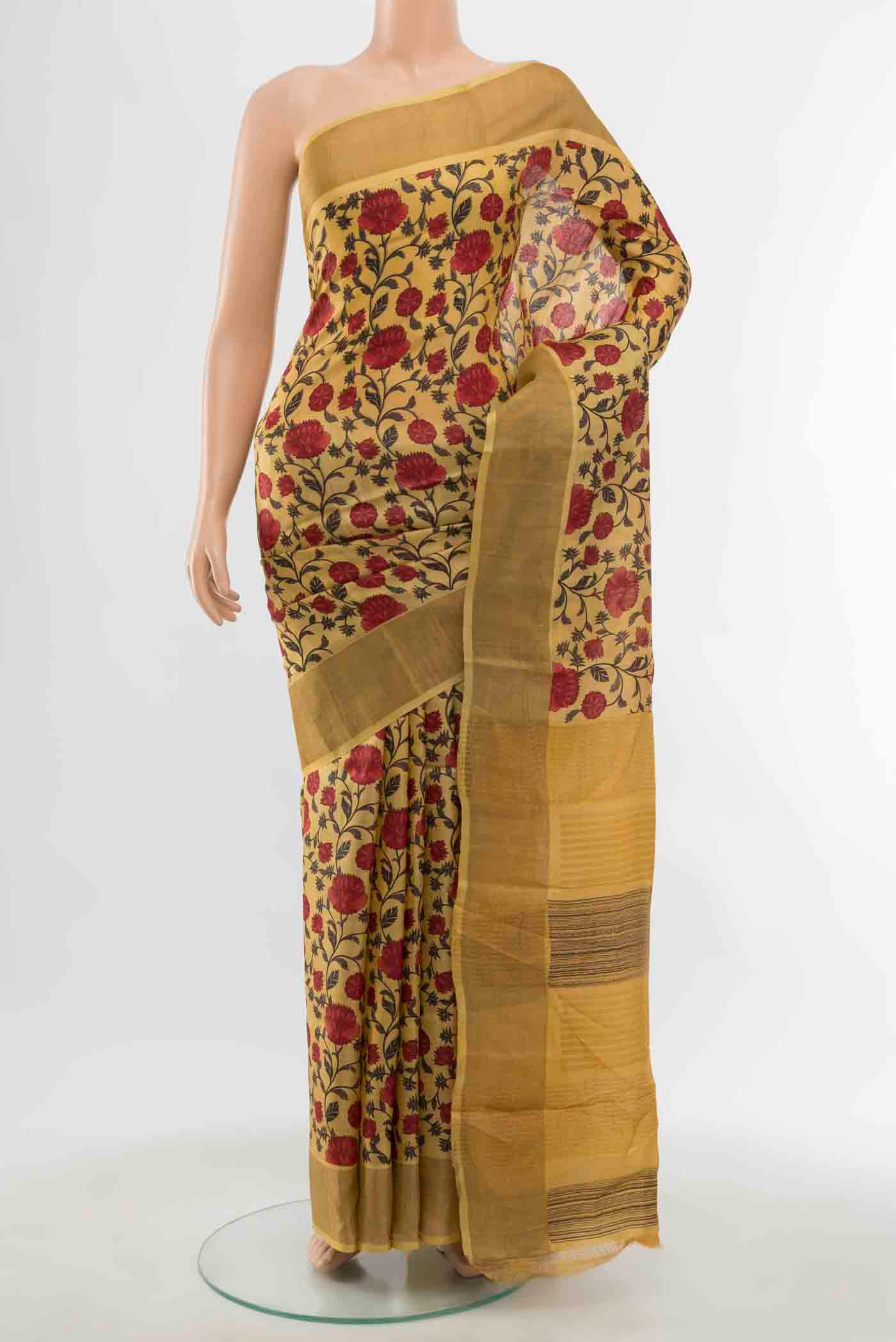 Mustard Tussar Saree with Floral Print on the body and Silk Border displayed on a mannequin
