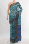 Sky Blue Tussar Silk Saree with Floral Print on the body and Silk Border.  displayed on a mannequin