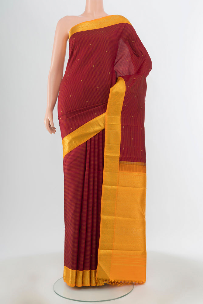 Maroon Kanchipuram Silk Saree with Zari Butta on the body and Silk Border.  displayed on a mannequin