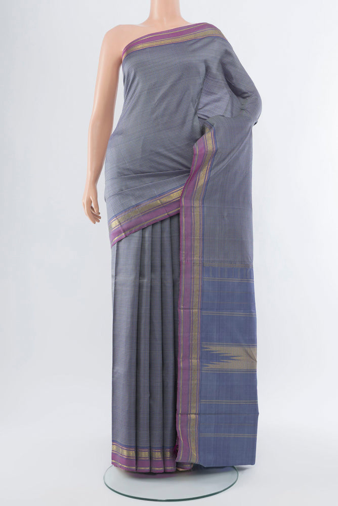Davys Grey Kanjivaram Silk Saree with Zari Butta on the body and Silk Border.  displayed on a mannequin
