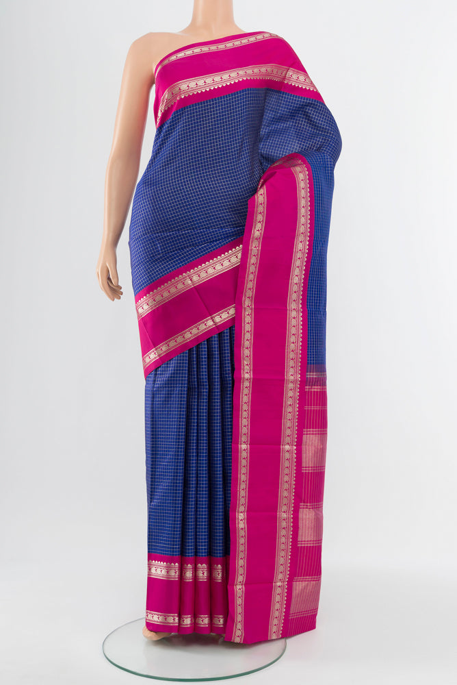 Dark Blue Kanjivaram Silk Saree with Zari Butta on the body and Silk Border.  displayed on a mannequin
