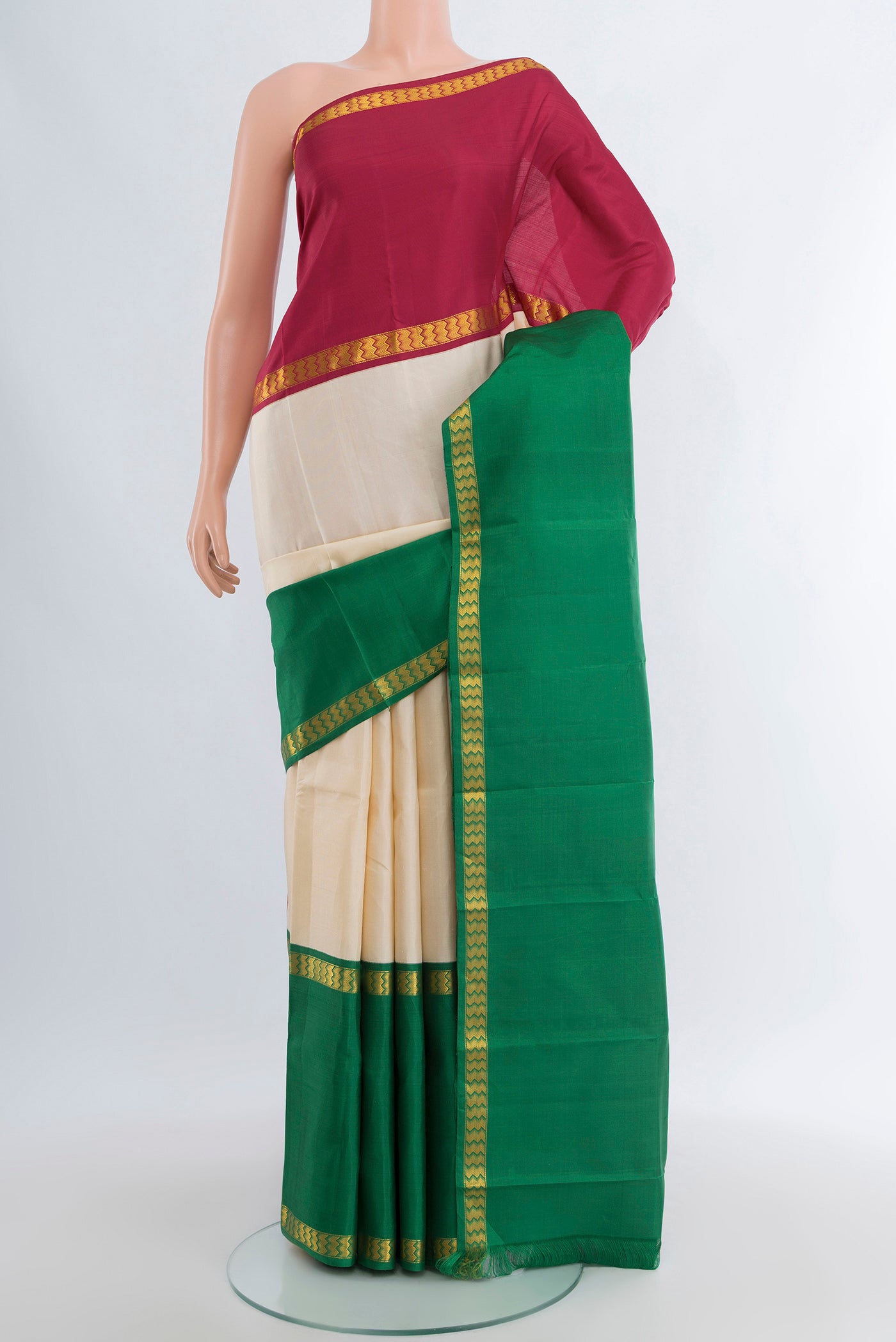 Cream Kanjivaram Silk Saree with Plain Body and Ganga Jamuna Border.  displayed on a mannequin