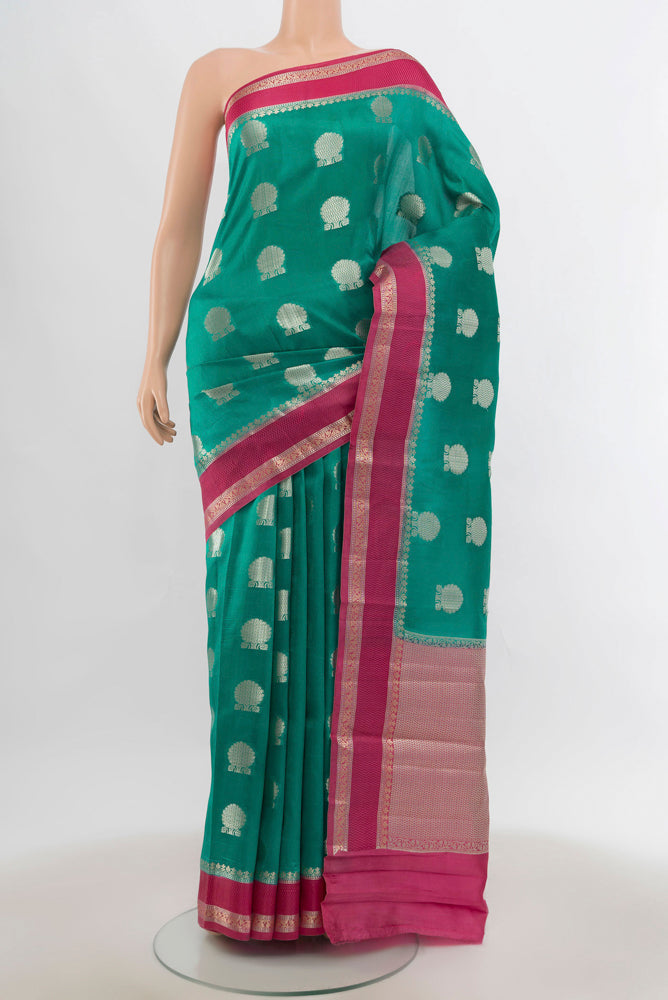 Light Blue Tussar Silk Saree with Zari Butta on the body and Silk Border.  displayed on a mannequin