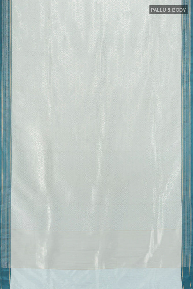 Flat view of Silver Banarasi Katan Silk Saree with Zari Butta on the body and Silk Border. 