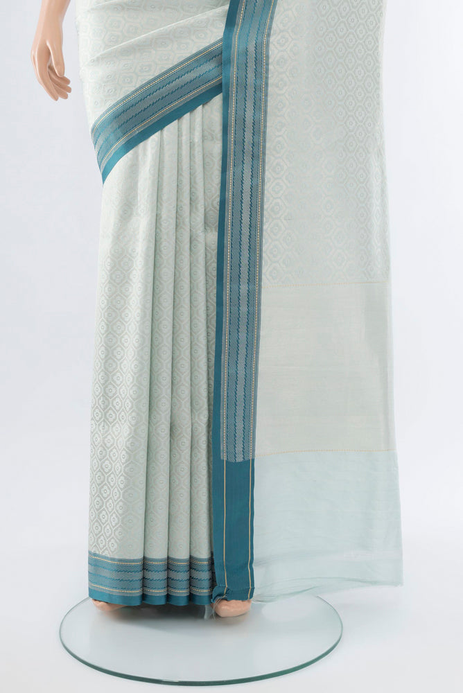 Pleats and pallu of Silver Banarasi Katan Silk Saree with Zari Butta on the body and Silk Border. 