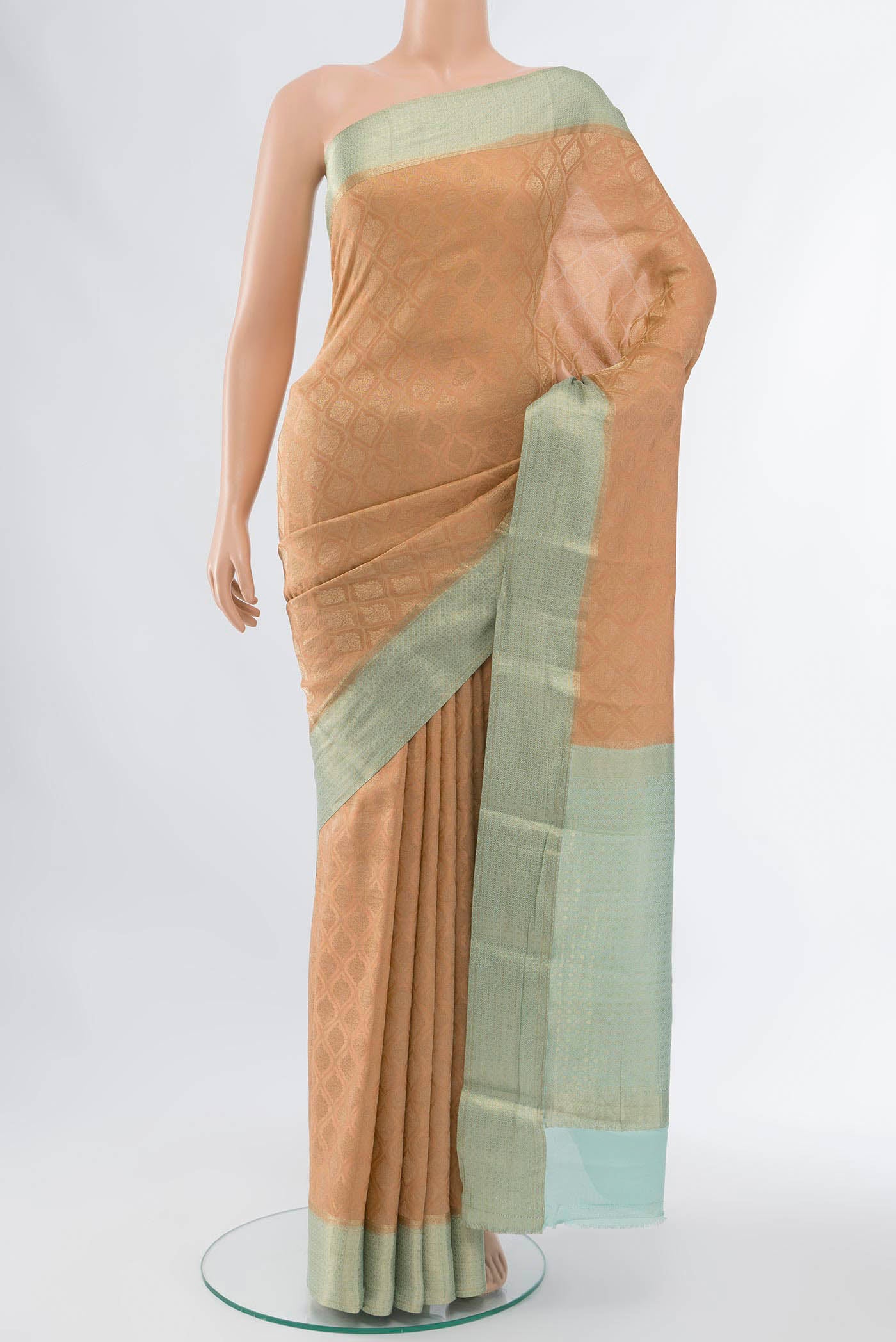 Peach Mysore Crepe Saree with Zari Butta on the body and Fancy Border displayed on a mannequin