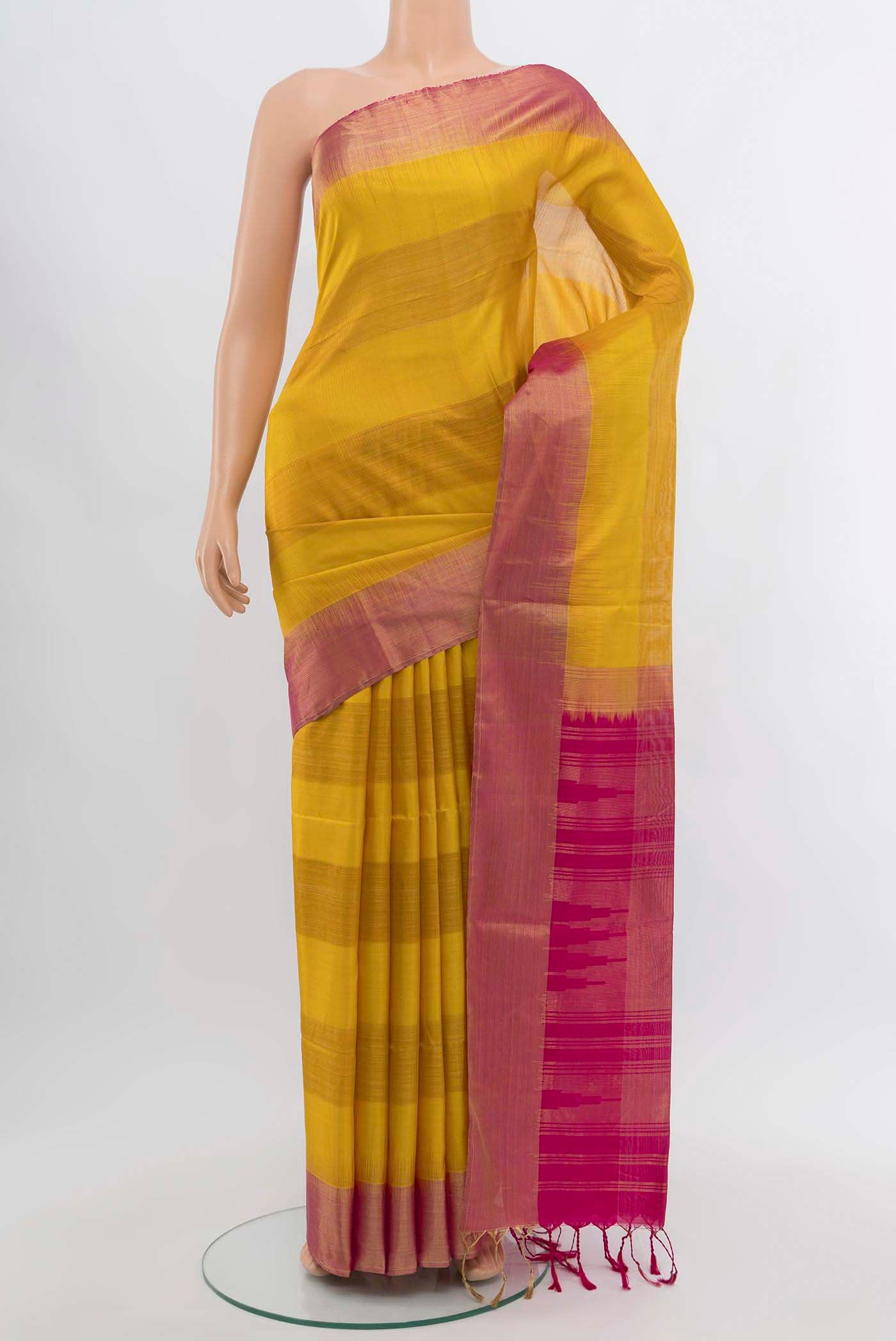 Mustard Soft Silk Saree with Zari Butta on the body and Silk Border displayed on a mannequin
