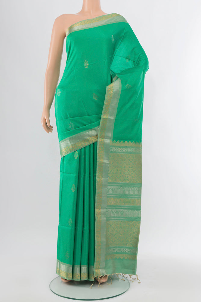 Light Green Soft Silk Saree with Zari Butta on the body and Silk Border.  displayed on a mannequin