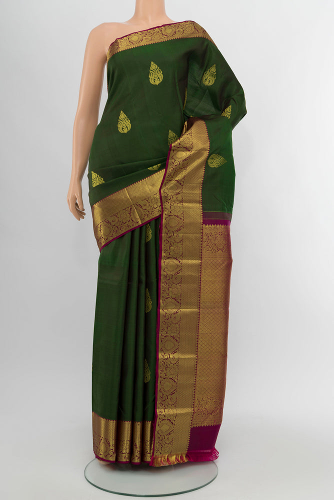 Mint Green Kanchipuram Silk Saree with Zari Butta on the body and Silk Border.  displayed on a mannequin