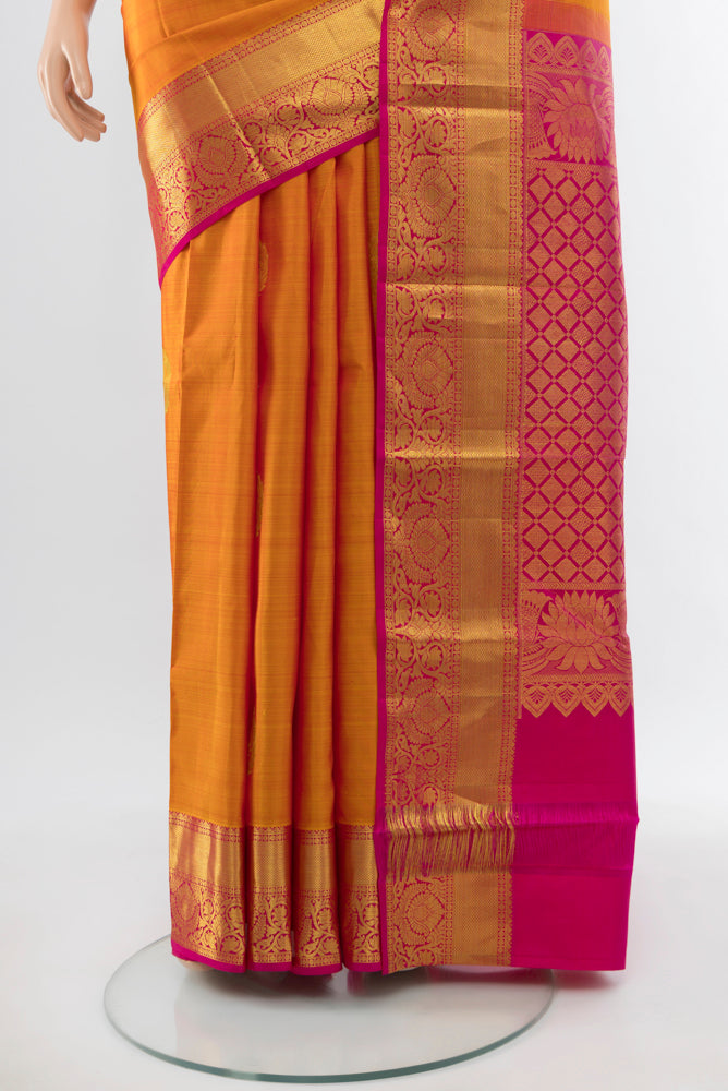 Pleats and pallu of Yellow Kanchipuram Silk Saree with Zari Butta on the body and Silk Border. 