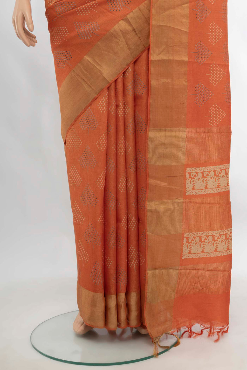 Pleats and pallu of Orange Tussar Silk Saree with Zari Butta on the body and Silk Border. 