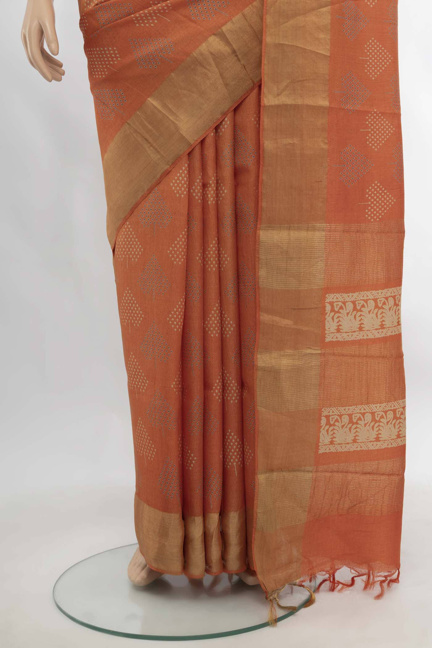 Pleats and pallu of Orange Tussar Silk Saree with Zari Butta on the body and Silk Border. 