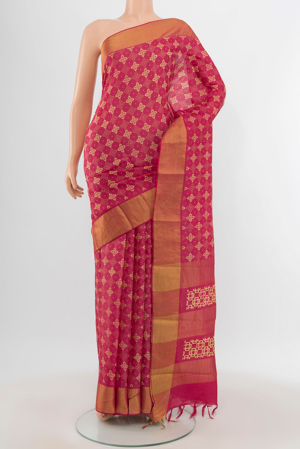 Pink Tussar Silk Saree with Floral Print on the body and Zari Border.  displayed on a mannequin