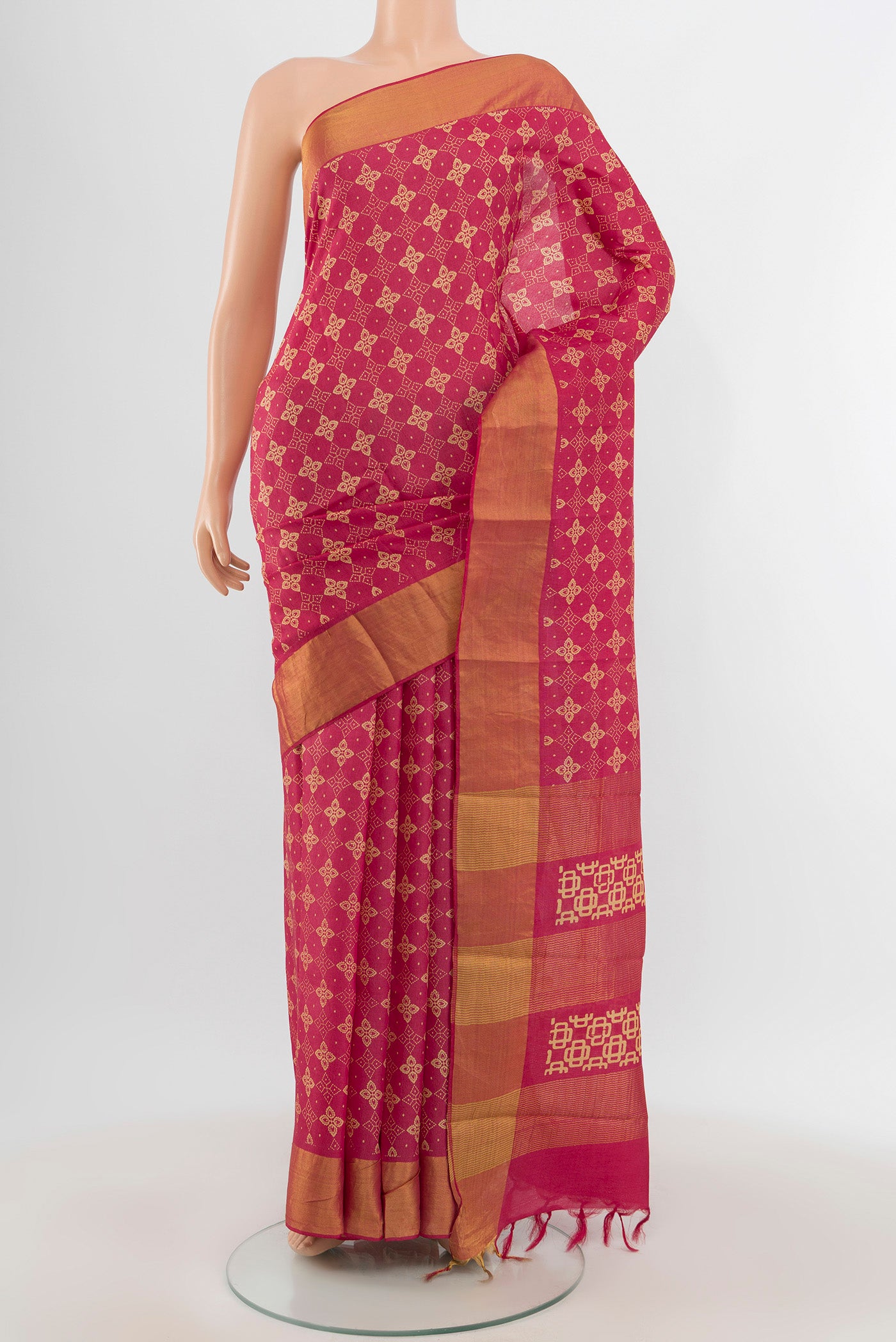 Pink Tussar Silk Saree with Floral Print on the body and Zari Border.  displayed on a mannequin