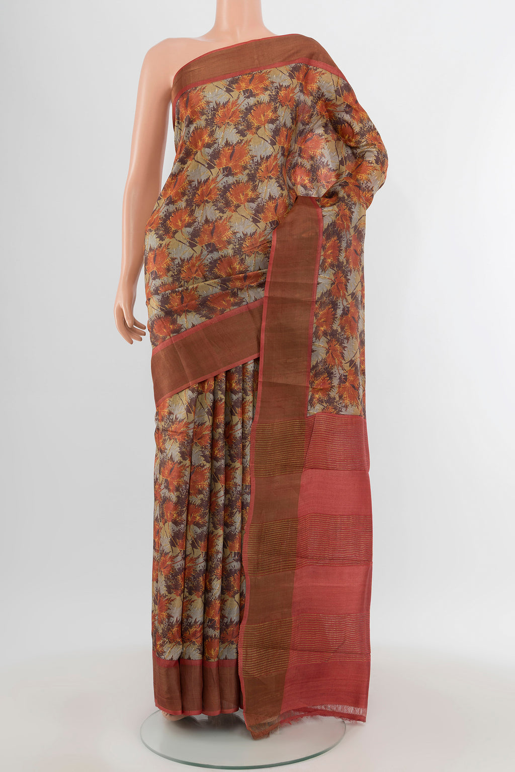 Beige Tussar Silk Saree with Floral Print on the body and Zari Border.  displayed on a mannequin
