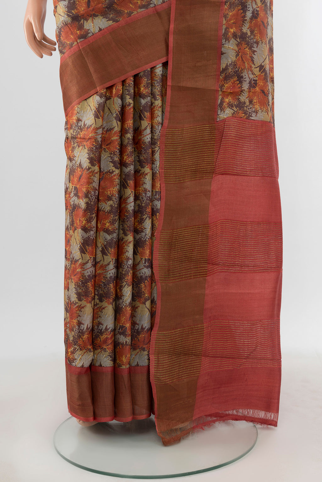 Pleats and pallu of Beige Tussar Silk Saree with Floral Print on the body and Zari Border. 