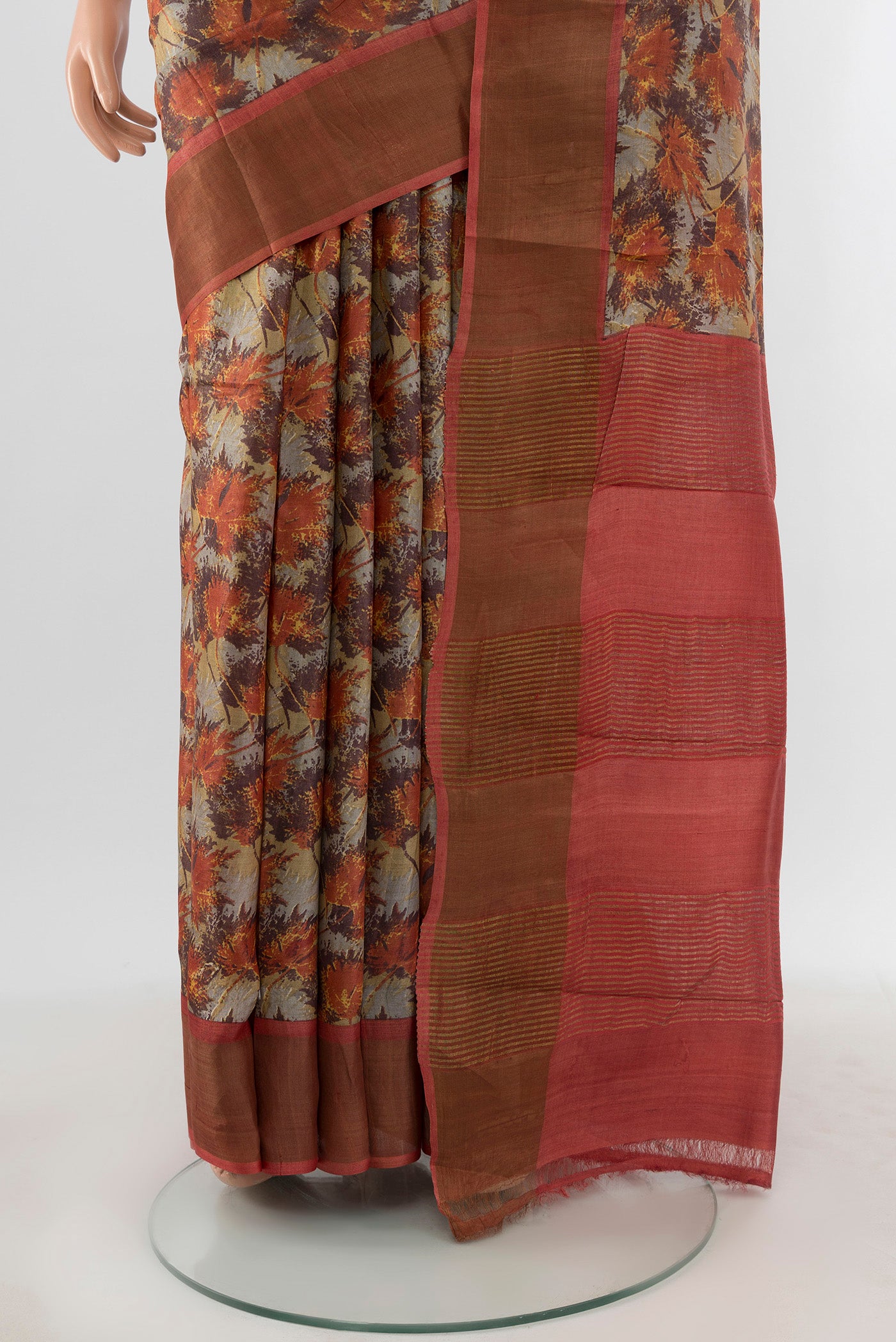 Pleats and pallu of Beige Tussar Silk Saree with Floral Print on the body and Zari Border. 