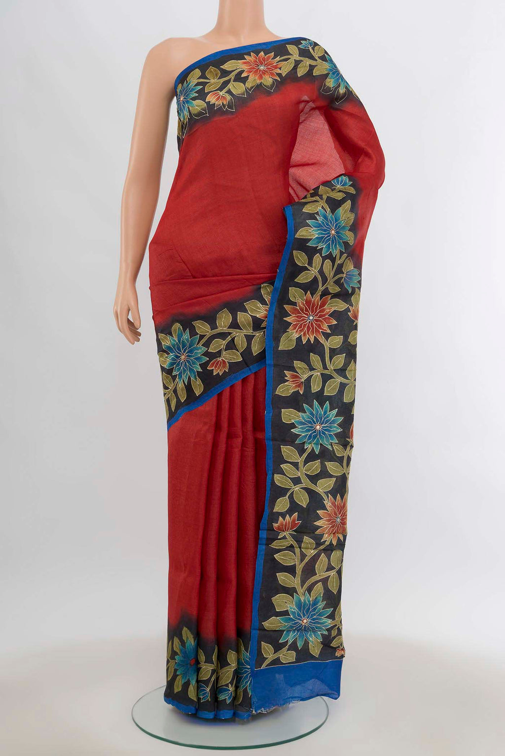 Peach Tussar Silk Saree with Floral Print on the body and Silk Border.  displayed on a mannequin