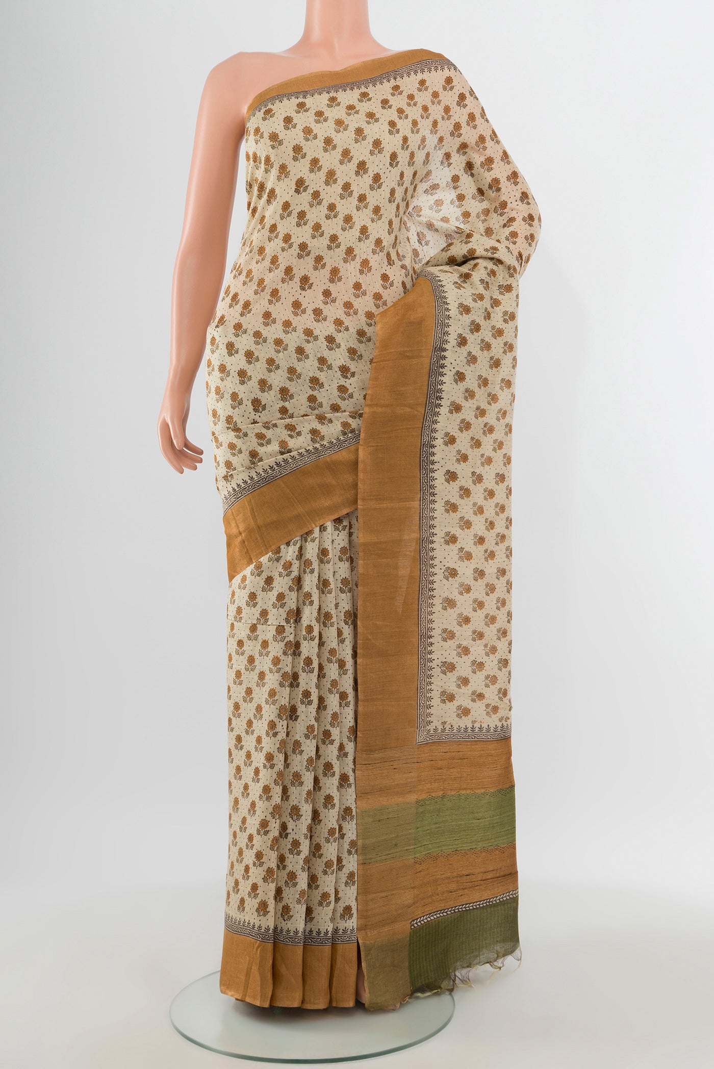 Cream Tussar Silk Saree with Floral Print on the body and Silk Border.  displayed on a mannequin