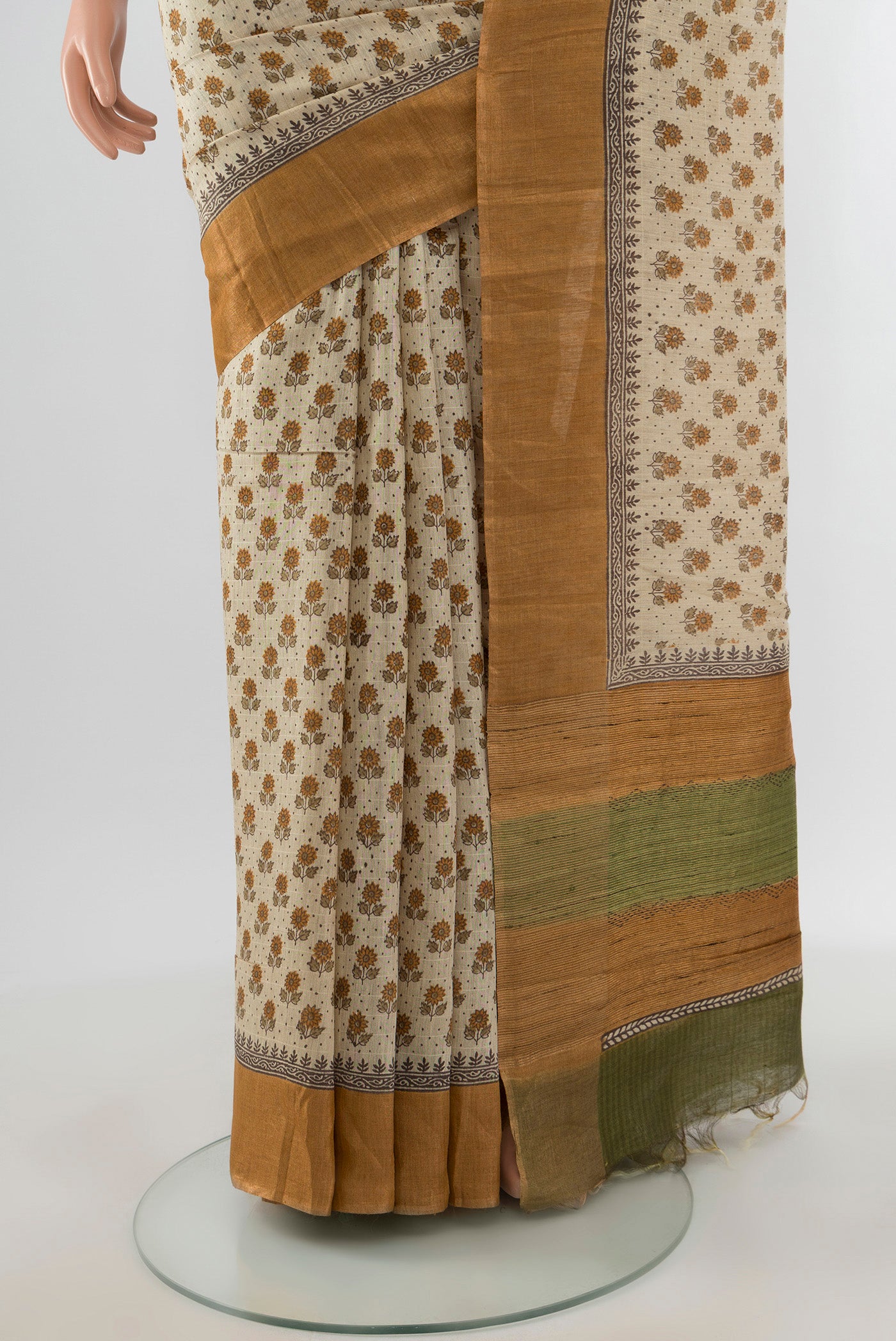 Pleats and pallu of Cream Tussar Silk Saree with Floral Print on the body and Silk Border. 