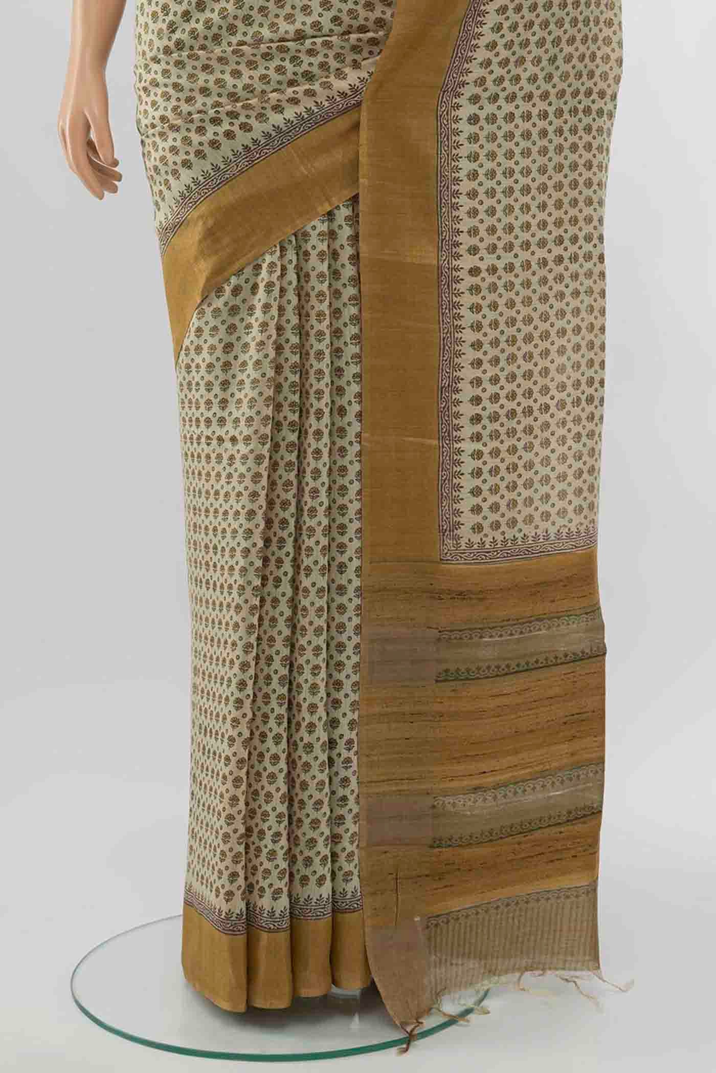 Pleats and pallu of Beige Tussar Silk Saree with Floral Print on the body and Silk Border