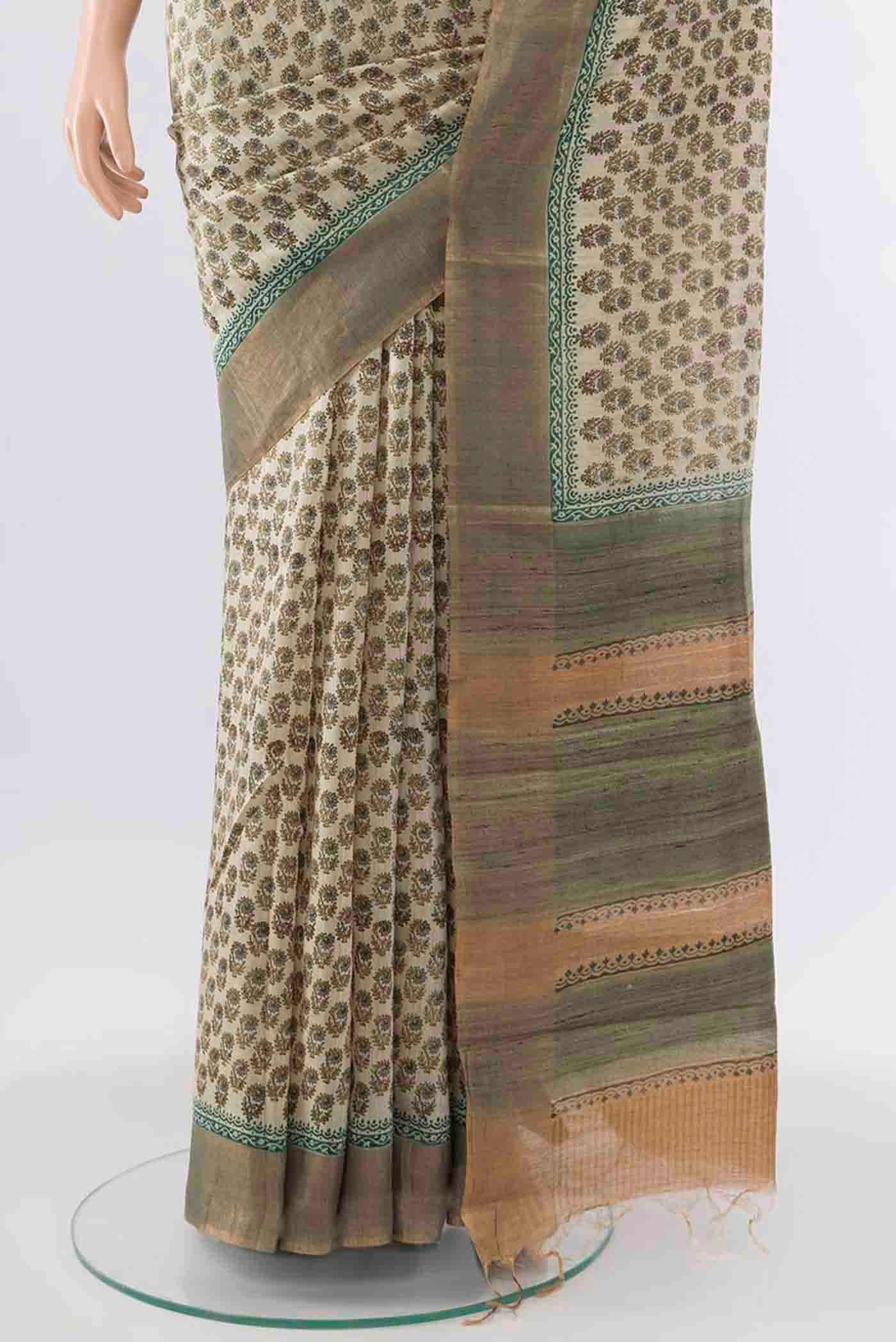 Pleats and pallu of Beige Tussar Silk Saree with Floral Print on the body and Zari Border