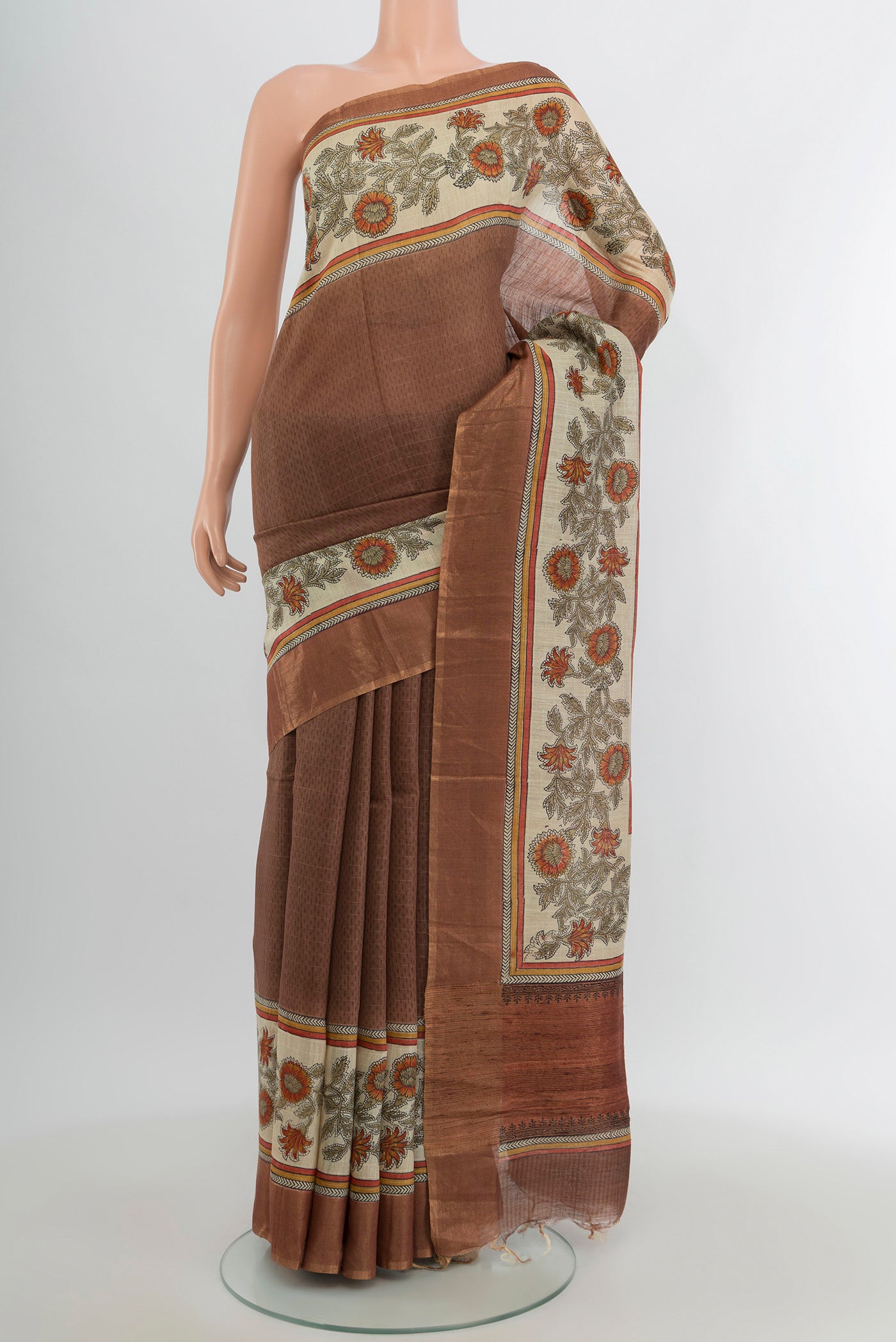 Brown Tussar Silk Saree with Printed design on the body and Printed Border.  displayed on a mannequin