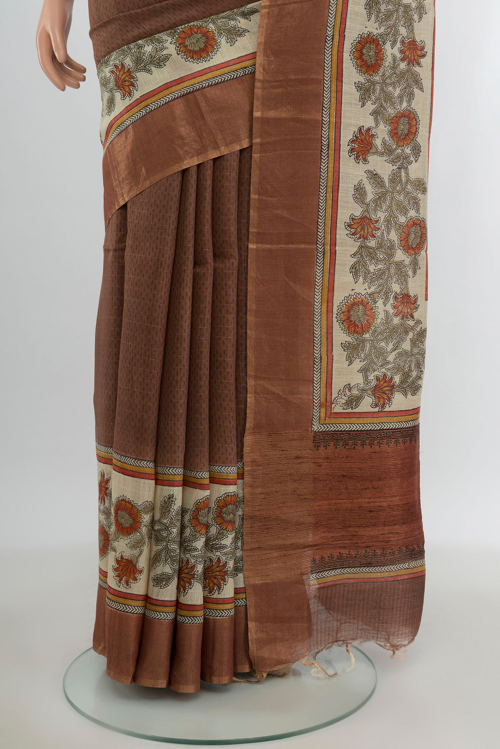 Pleats and pallu of Brown Tussar Silk Saree with Printed design on the body and Printed Border. 