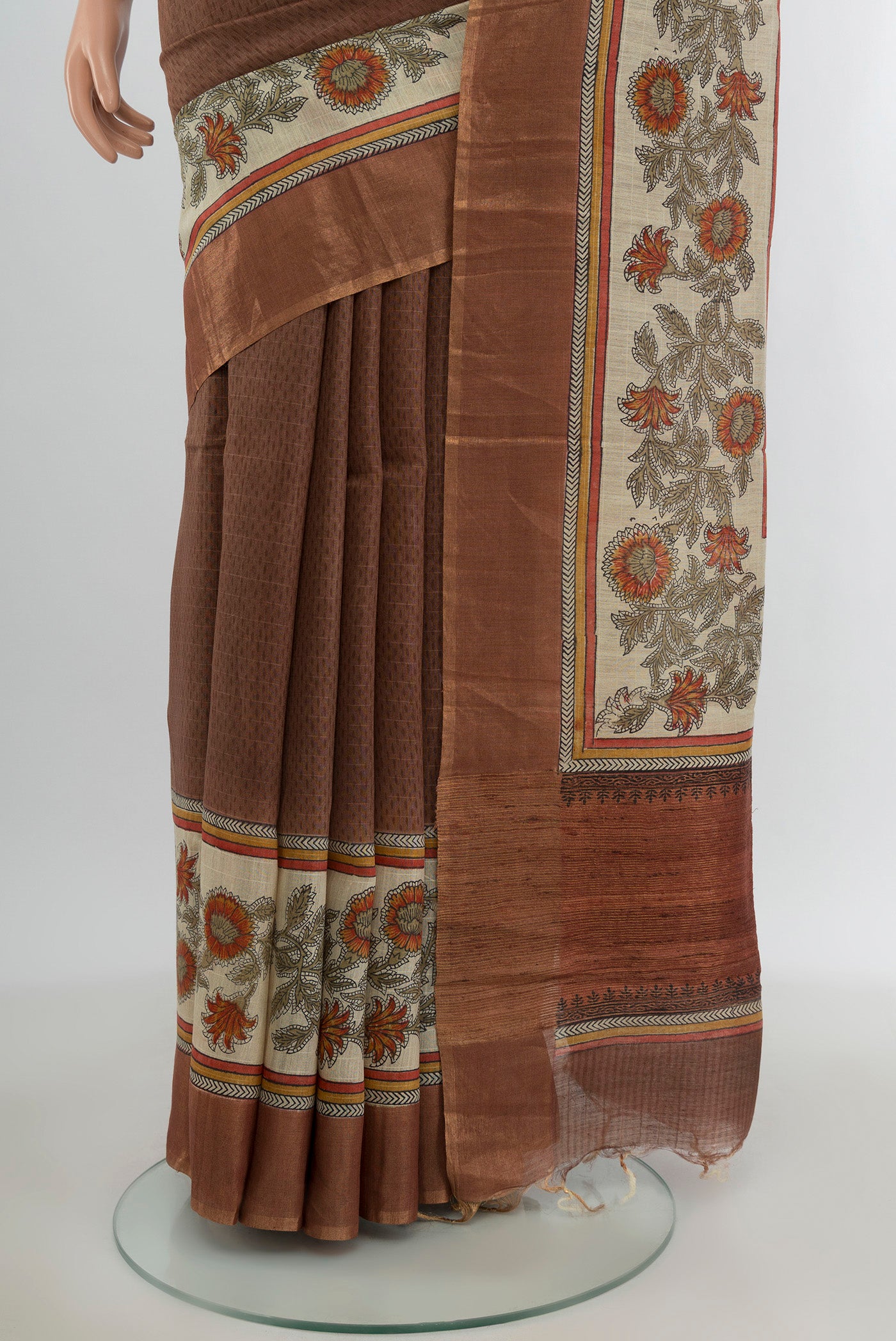 Pleats and pallu of Brown Tussar Silk Saree with Printed design on the body and Printed Border. 